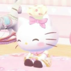 a hello kitty doll sitting on top of a pink rug