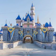 the entrance to sleeping beauty castle at disneyland world in california, usa with blue and pink turrets