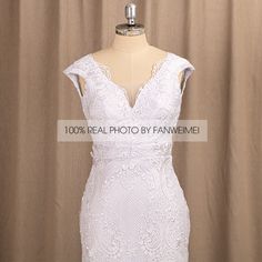 a white wedding dress on a mannequin