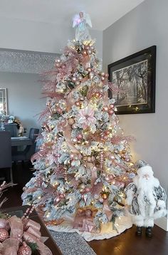 a pink and silver christmas tree in a living room