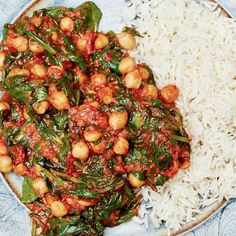 a plate filled with rice and spinach covered in red sauce next to white rice