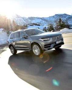 an suv driving down a road in the mountains