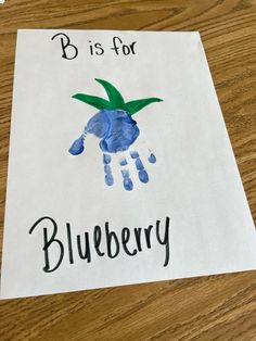 a piece of paper with the words b is for blueberry on it and a handprint