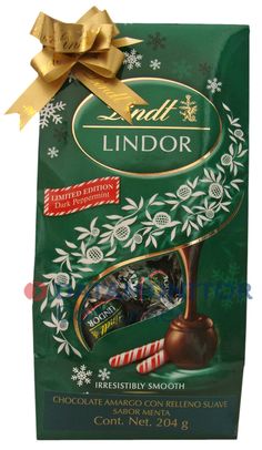 lindor chocolate candy bar with gold ribbon and holiday decorations on the front, wrapped in green paper