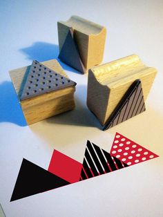 three wooden blocks with different shapes and sizes sitting on top of a white table next to each other