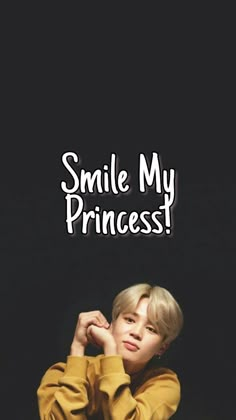 a boy sitting down with the words smile my princess on his face and in front of him