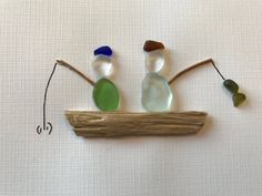 three glass birds sitting on top of a piece of wood