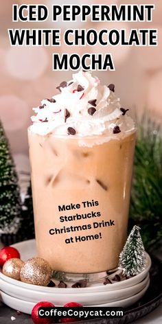 an iced peppermint white chocolate mocha on a plate with christmas decorations around it