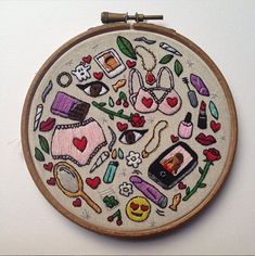 an embroidered hoop with various items on it