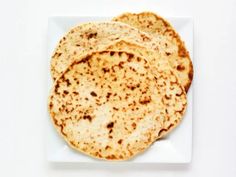 three flat breads on a white plate