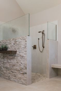 a bathroom with a walk in shower sitting next to a sink and a mirror on the wall