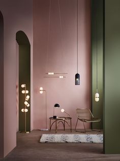 a room with pink walls and two chairs