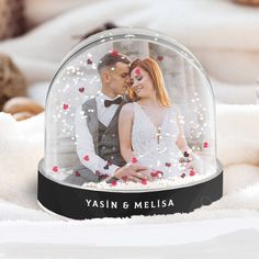 a couple under a glass dome with hearts on it