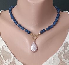 Handmade necklace from navy blue natural lapis lazuli beads with pendant pearl Baroque. Necklace will be a good gift, anniversary, or birthday. gift for wife, gift for girlfriend, gift for sister, gift for mom, gift for daughter, gift for her. Materials: lapis lazuli, Baroque pearl size 25x15x5 mm, 14K details.  Necklace length +/- 17.7" - 45 cm). Recommendations for care: Do not wet, do not drop, avoid contact with perfumes, detergents. Wear with pleasure! IMPORTANT!  All items are shipped with Blue Lapis Lazuli Pearl Necklace Gift, Blue Beaded Necklace With Pearl Drop For Gift, Blue Pendant Pearl Necklace As Gift, Blue Pendant Pearl Necklace For Gift, Blue Pearl Necklace With Pearl Pendant For Gift, Baroque Necklace, Pearl Baroque, Necklace With Pearl, Lapis Lazuli Beads