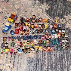 a pile of toy figurines sitting on top of a carpet next to a rug