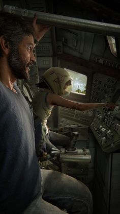 a man is sitting in the cockpit of a plane and pointing at something on the screen