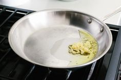 a pan with some food inside of it on top of an oven burner,