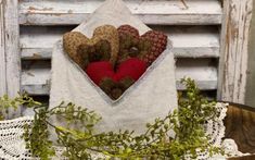 a bag filled with hearts sitting on top of a table next to a potted plant