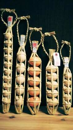 four baskets filled with eggs sitting on top of a wooden table next to each other