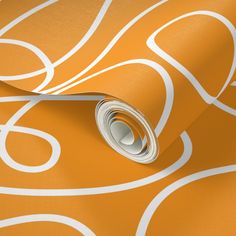 an orange wallpaper with white swirls and circles in the center, on a plain surface