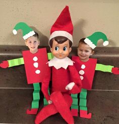 two children in elf costumes sitting next to each other