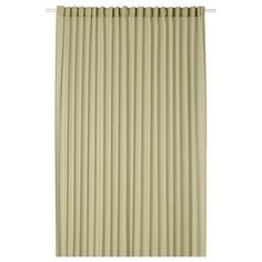 a beige curtain with vertical pleating on the top and bottom, in front of a white