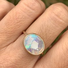 Not your traditional Opal ring, set in 14k gold with an open back this Australian White Opal rests atop a hand textured band. Approximate stone size: 14mm x 11mm Approx ct weight: 2.75ct This one of a kind piece is handmade to order in Emily's Hudson Valley studio. If you have questions about sizing, shipping or need help deciding please reach out to us! Boulder Opal Ring, Australian Opal Ring, Australian Boulder Opal, Local Jewelry, Australian Opal, Opal Ring, Boulder Opal, Hudson Valley, White Opal