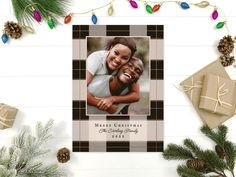 a christmas card with an image of two people hugging each other