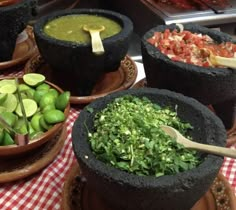 several bowls filled with different types of food