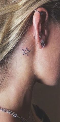 a woman with a star tattoo behind her ear