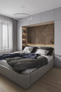 a large bed sitting in the middle of a bedroom next to a wall mounted book shelf