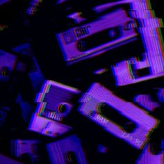 an abstract image of cassettes stacked on top of each other in blue and purple