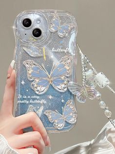 a woman holding up a phone case with butterflies on it