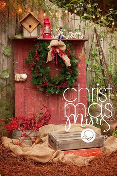 christmas music is displayed in front of an old red door with wreaths and decorations