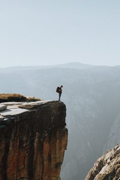 a person standing on the edge of a cliff