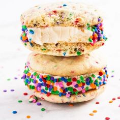 three cookies stacked on top of each other with sprinkles and frosting