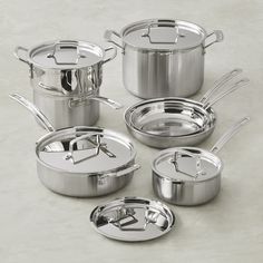 an assortment of stainless steel pots and pans