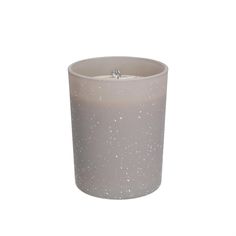 a white candle with silver speckles on the top and bottom, sitting in front of a white background