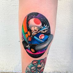 a person with a mario kart tattoo on their leg