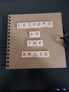 the words letters to the bride are spelled with scrabbles on a notebook