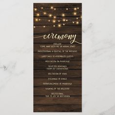 the rustic wood and string lights ceremony card