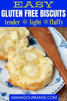 two gluten free biscuits on a blue and white plate with a wooden spoon