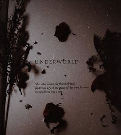 the words underworld are written on a piece of paper next to some dead flowers