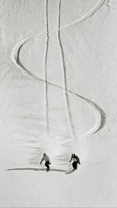 two people skiing down a snow covered slope