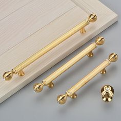 three golden door handles and two knobs