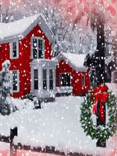 a red house covered in snow with a wreath