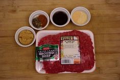 raw ground beef, spices and seasonings on a wooden table