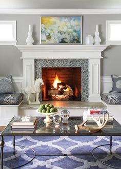 a living room filled with furniture and a fire place under a painting on the wall