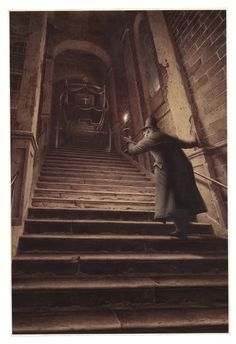 an old photo of a man walking up some stairs with his hand in the air