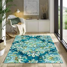 a blue area rug with an ornate design on the floor in a modern living room